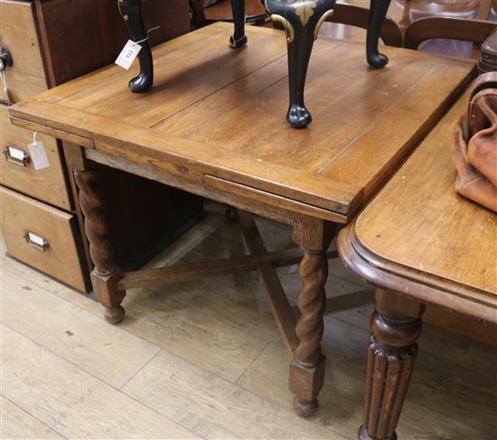 A 1920s oak drawleaf table
